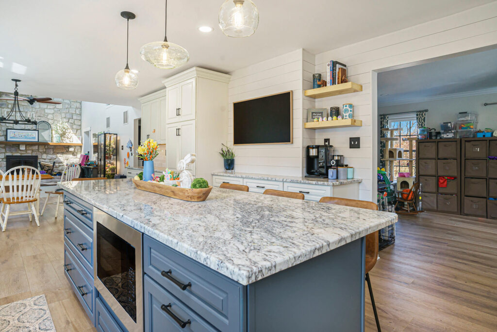Modern kitchen remodel with white shaker cabinets, blue island, granite countertops, and open shelving by Pottstown Construction Company