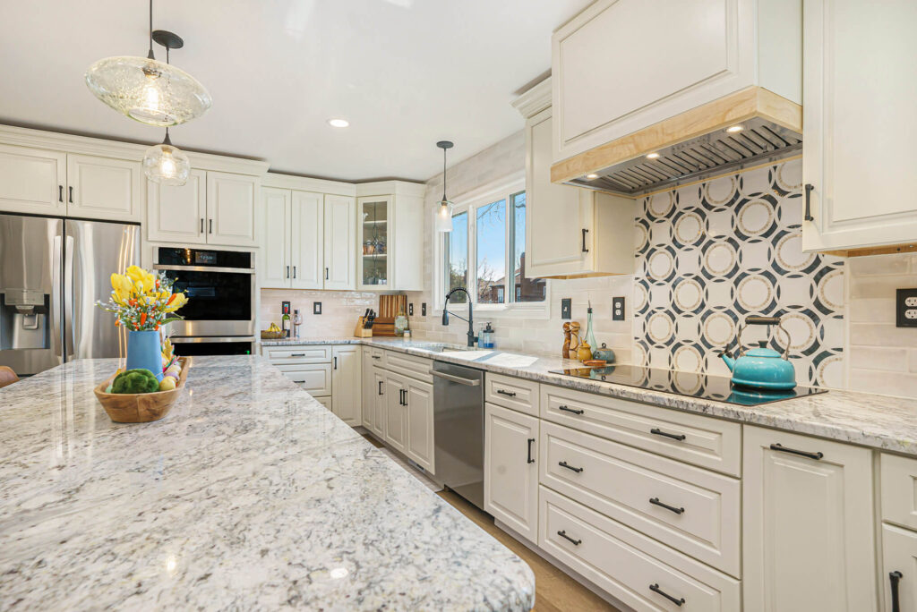 Modern kitchen remodel with white shaker cabinets, granite countertops, and geometric tile backsplash by Pottstown Construction