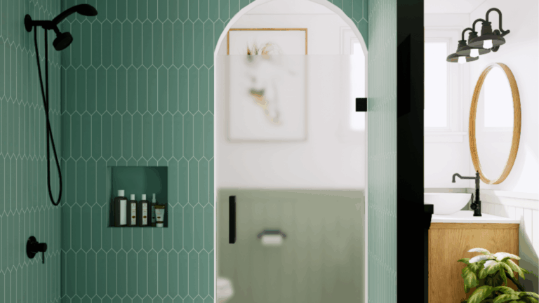Modern bathroom remodel with seafoam green tile walls, arched shower niche, wooden vanity, and brass round mirror