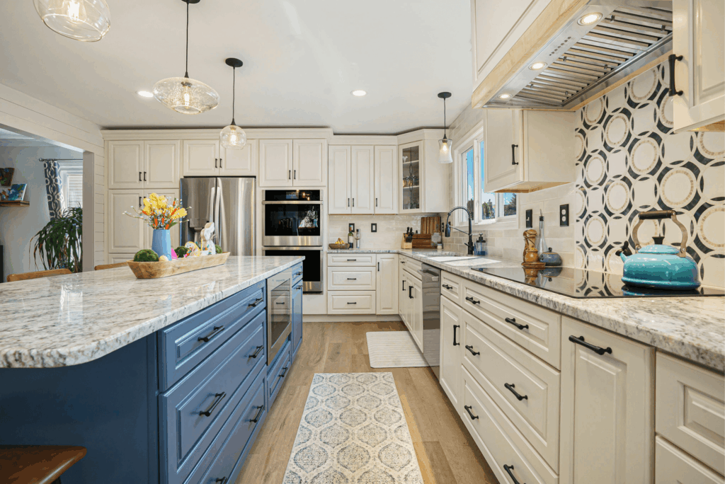 Modern kitchen remodel with white shaker cabinets, blue island, granite countertops, and stainless steel appliances