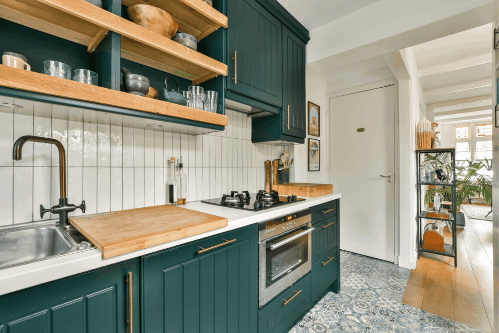 Modern kitchen remodel with forest green cabinets, wood shelving, white subway tile backsplash, and butcher block countertops