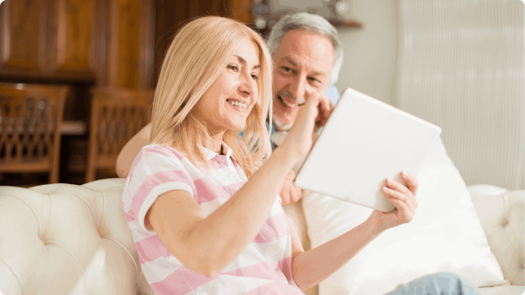 Our Construction Process 1 Homeowners reviewing renovation plans and blueprints together in living room with wood cabinetry