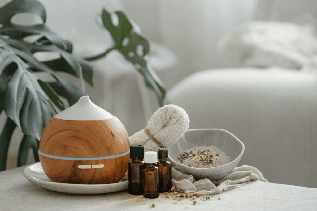 Spa bathroom decor with essential oils, towels, and natural elements on white counter
