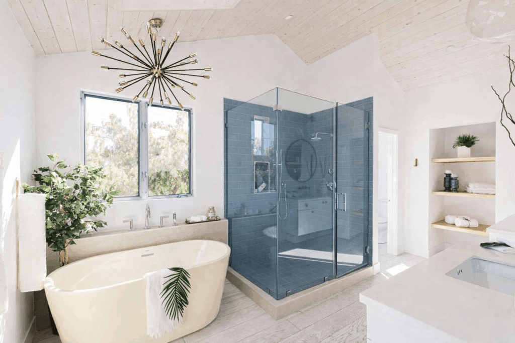Modern master bathroom remodel with freestanding soaking tub and frameless glass walk-in shower enclosure