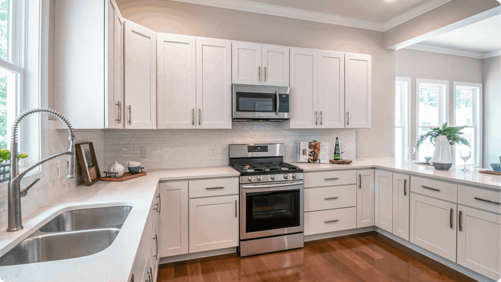 Our Construction Process 5 Modern kitchen remodel with white shaker cabinets, quartz countertops, and stainless steel appliances by Pottstown Construction Company.