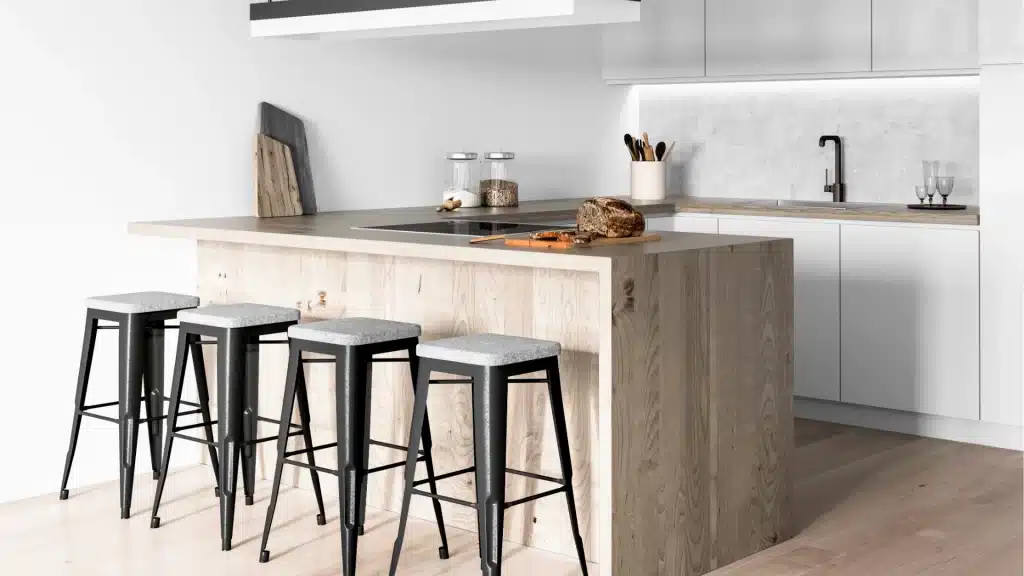 Modern kitchen remodel with white cabinetry, wood island, black bar stools, and quartz countertops