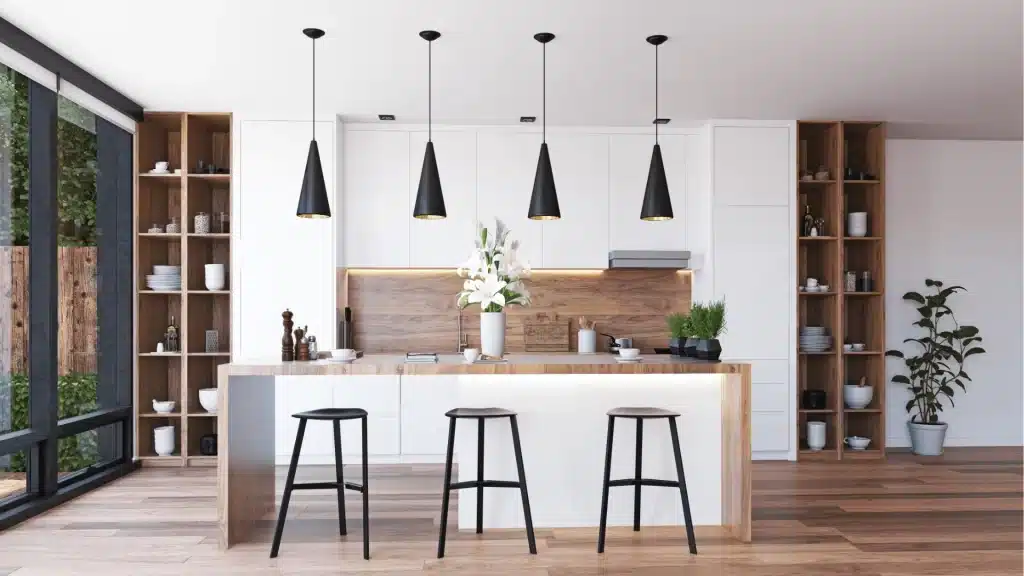 Modern kitchen remodel with white cabinetry, wood countertops, black pendant lights, and built-in shelving