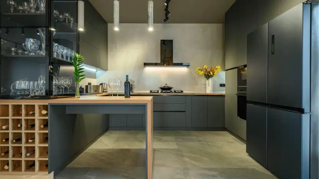 Modern kitchen remodel with dark gray cabinetry, wood countertops, white backsplash, pendant lighting, and built-in wine storage