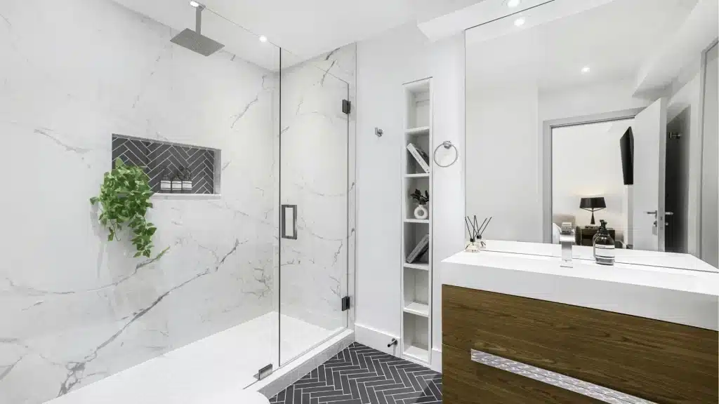 Modern luxury bathroom remodel with marble tile, walk-in shower, floating vanity, and herringbone floor tile