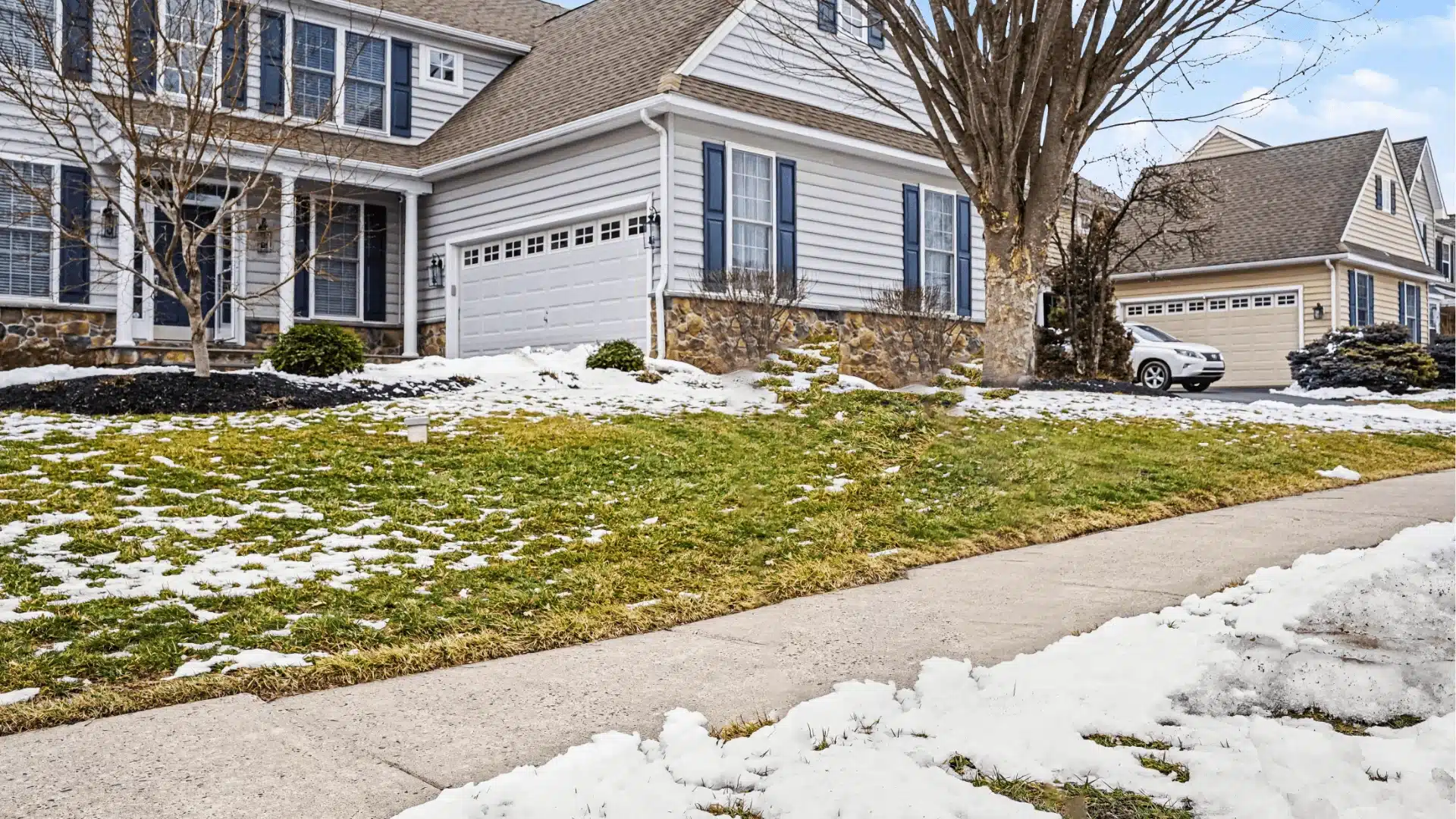 Blog 78 Modern white vinyl siding home with two-car garage and stone accents in suburban neighborhood