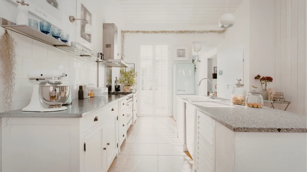 Modern white kitchen remodel with shaker cabinets, quartz countertops, and subway tile backsplash