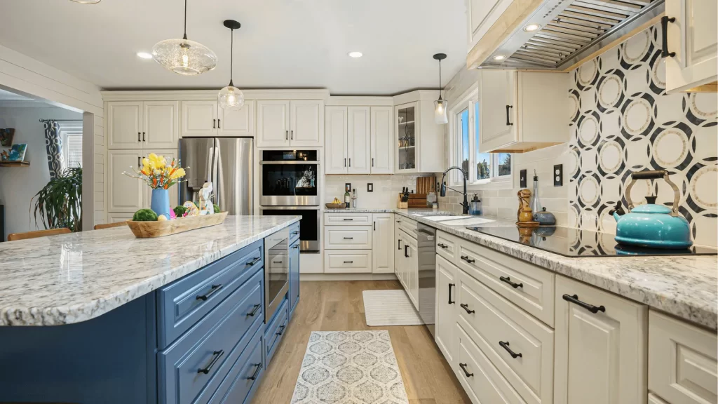 Modern kitchen remodel with white shaker cabinets, blue island, granite countertops, and stainless steel appliances