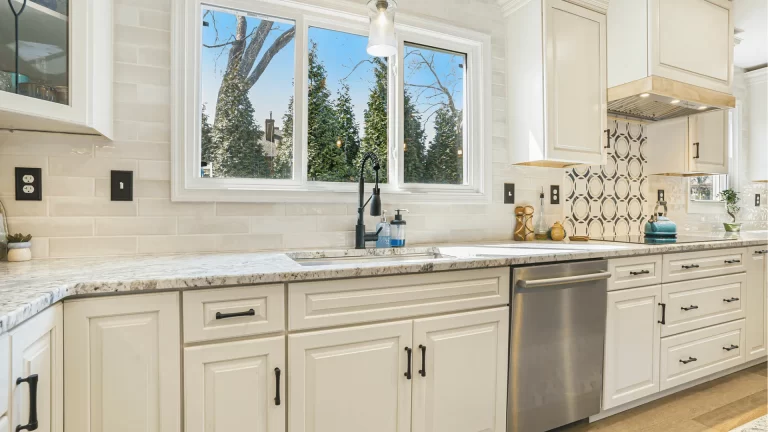 Modern kitchen remodel with cream shaker cabinets, granite countertops, and stainless steel appliances