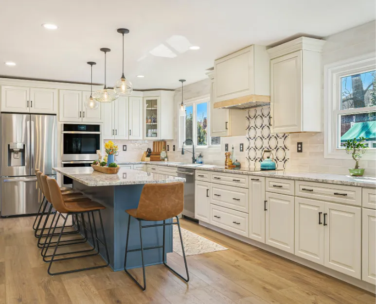 Modern kitchen remodel with white shaker cabinets, blue island, granite countertops, and stainless steel appliances