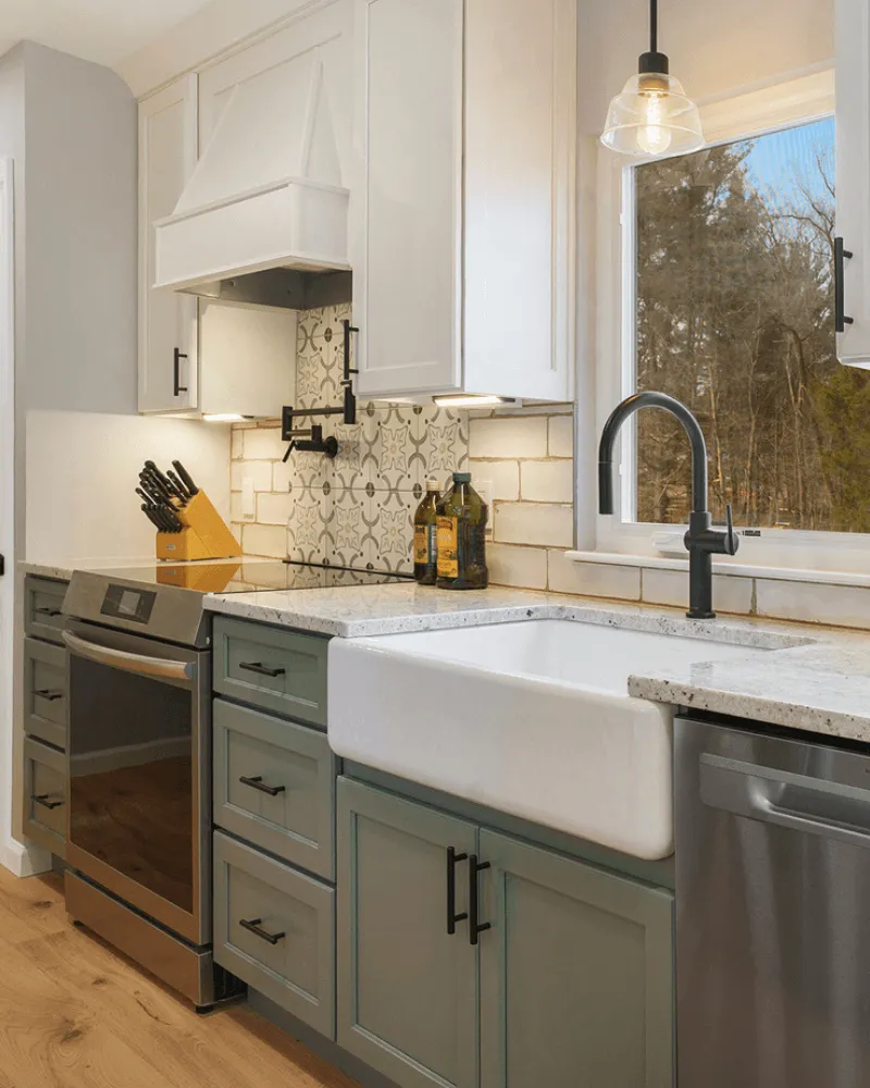 Modern kitchen remodel with white shaker cabinets, green base cabinets, farmhouse sink, and subway tile backsplash