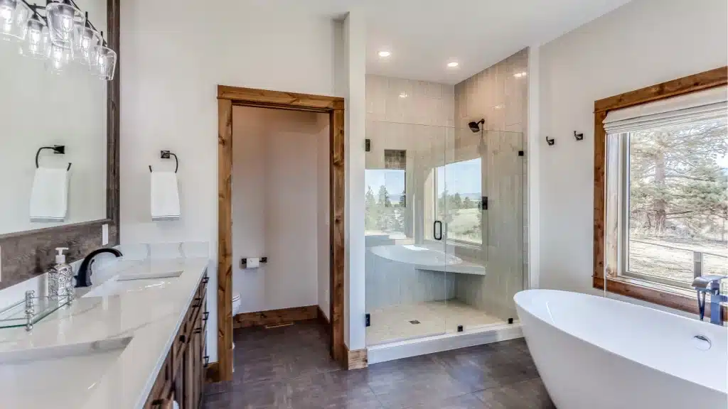Walk-in glass shower with bench and double niche