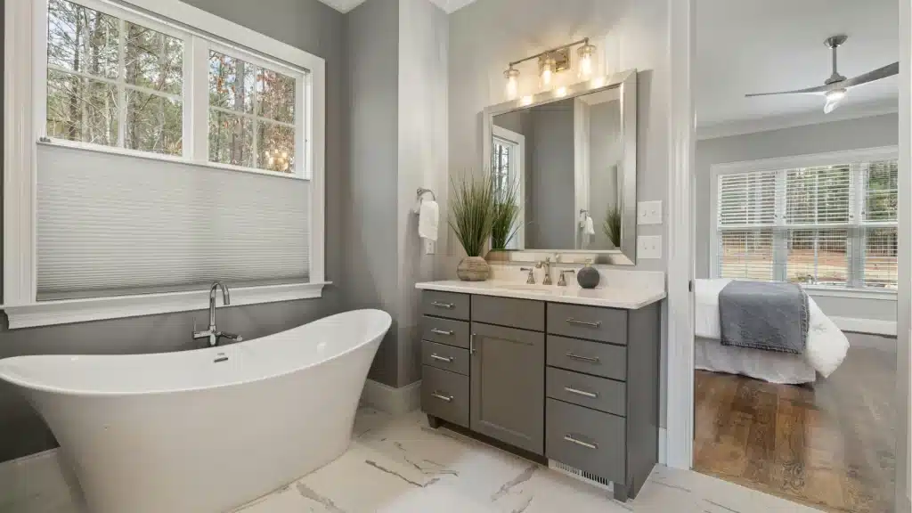 Spacious master bathroom with freestanding tub and grey vanity