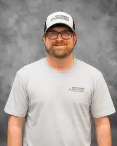 Pottstown Construction Co. team member wearing company branded cap and t-shirt with design and remodeling logo
