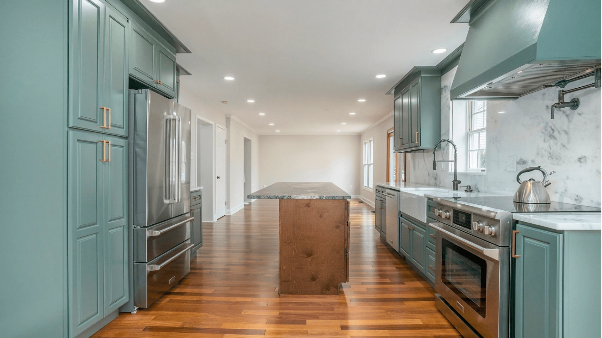 Blog 63 Modern kitchen remodel with sage green cabinets, stainless steel appliances, marble backsplash, and hardwood flooring