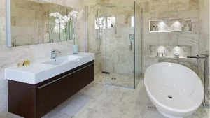 Luxury bathroom remodel with marble tile, freestanding soaking tub, frameless glass shower, and double vanity