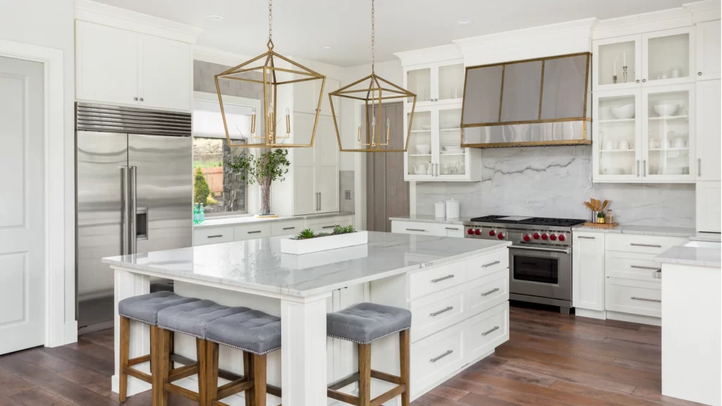 Modern white kitchen remodel with white shaker cabinets, quartz countertops, marble backsplash, and stainless steel appliances