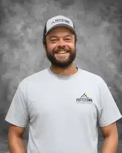 Pottstown Construction Company team member wearing branded cap and shirt with logo