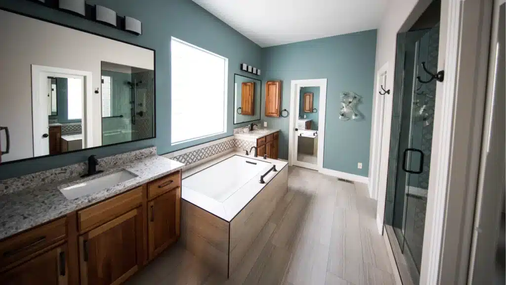 Luxury bathroom remodel with wood vanity, soaking tub, and glass shower