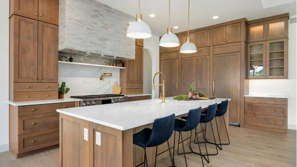 Modern kitchen remodel with wood cabinets, marble countertops, island seating, and pendant lighting by Pottstown Construction