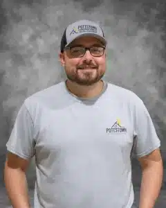 Pottstown Construction Company team member wearing branded cap and shirt with company logo