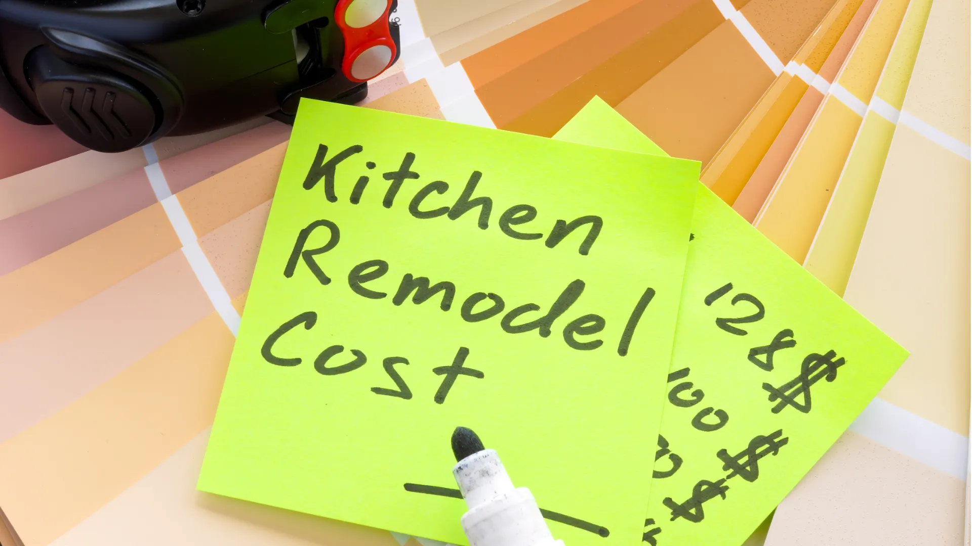 Blog 65 Kitchen remodel cost estimate note with paint color samples and construction planning tools on desk
