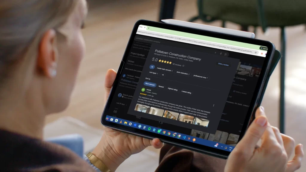 Woman viewing Pottstown Construction Company's 5.0-star Google reviews and project photos on a tablet
