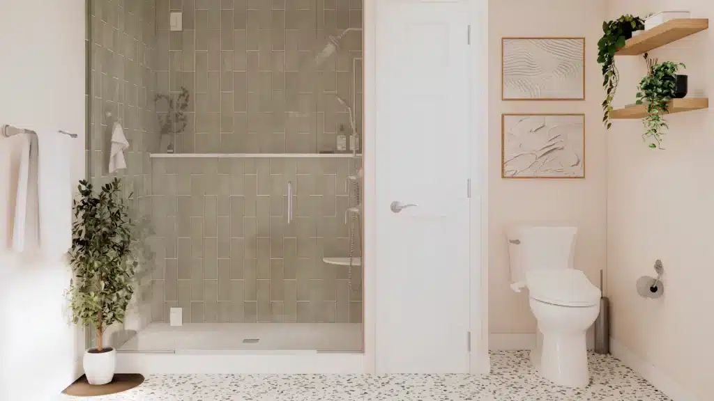 Modern bathroom with sage green vertical tile walk-in shower, frameless glass door, and terrazzo floor